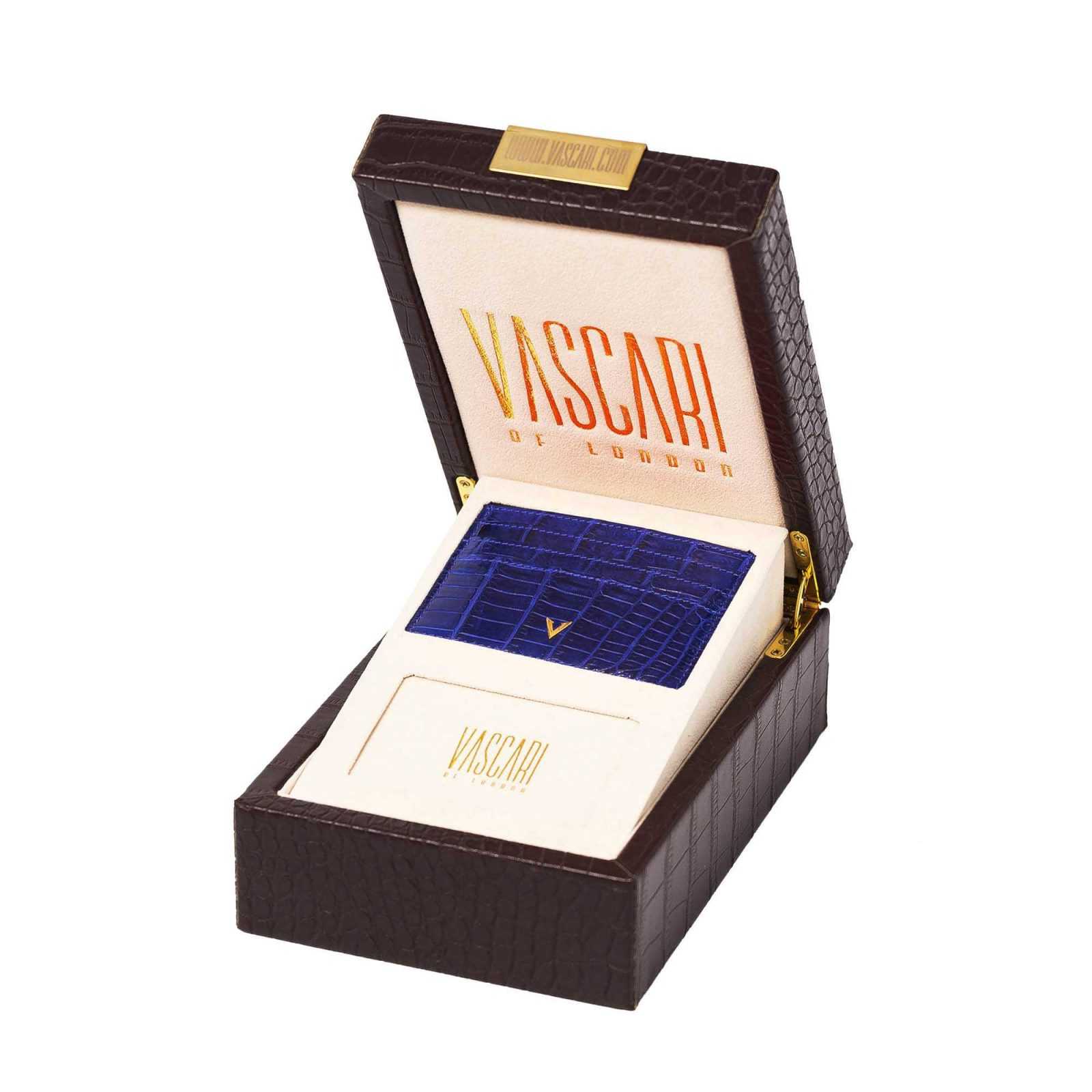 Vascari Gloss blue crocodile leather cardholder, gold logo side view in a box 